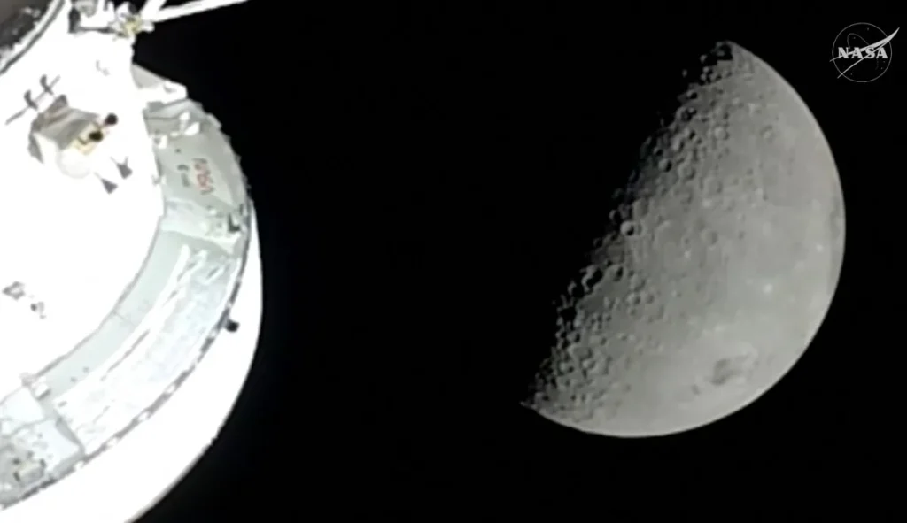 This screengrab from a NASA livestream shows the Orion spacecraft approaching the Moon on April 6, 2026. The four astronauts embarking on NASA's flyby of the Moon became on April 6 the humans to travel furthest from our planet, as they began the lunar observation that is core to their mission. The Artemis II team broke the distance record set by the 1970 Apollo 13 mission, which they are expected to surpass by 4,105 miles (6,606 kilometers) when they reach this journey's anticipated furthest distance from Earth -- 252,760 miles (406,778 kilometers) -- later today. (Photo by Handout / NASA / AFP) / RESTRICTED TO EDITORIAL USE - MANDATORY CREDIT "AFP PHOTO / NASA" - HANDOUT - NO MARKETING NO ADVERTISING CAMPAIGNS - DISTRIBUTED AS A SERVICE TO CLIENTS