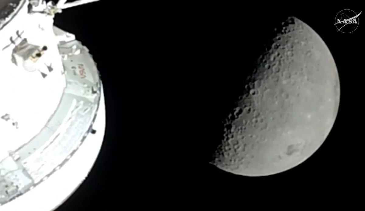 This screengrab from a NASA livestream shows the Orion spacecraft approaching the Moon on April 6, 2026. The four astronauts embarking on NASA's flyby of the Moon became on April 6 the humans to travel furthest from our planet, as they began the lunar observation that is core to their mission. The Artemis II team broke the distance record set by the 1970 Apollo 13 mission, which they are expected to surpass by 4,105 miles (6,606 kilometers) when they reach this journey's anticipated furthest distance from Earth -- 252,760 miles (406,778 kilometers) -- later today. (Photo by Handout / NASA / AFP) / RESTRICTED TO EDITORIAL USE - MANDATORY CREDIT "AFP PHOTO / NASA" - HANDOUT - NO MARKETING NO ADVERTISING CAMPAIGNS - DISTRIBUTED AS A SERVICE TO CLIENTS