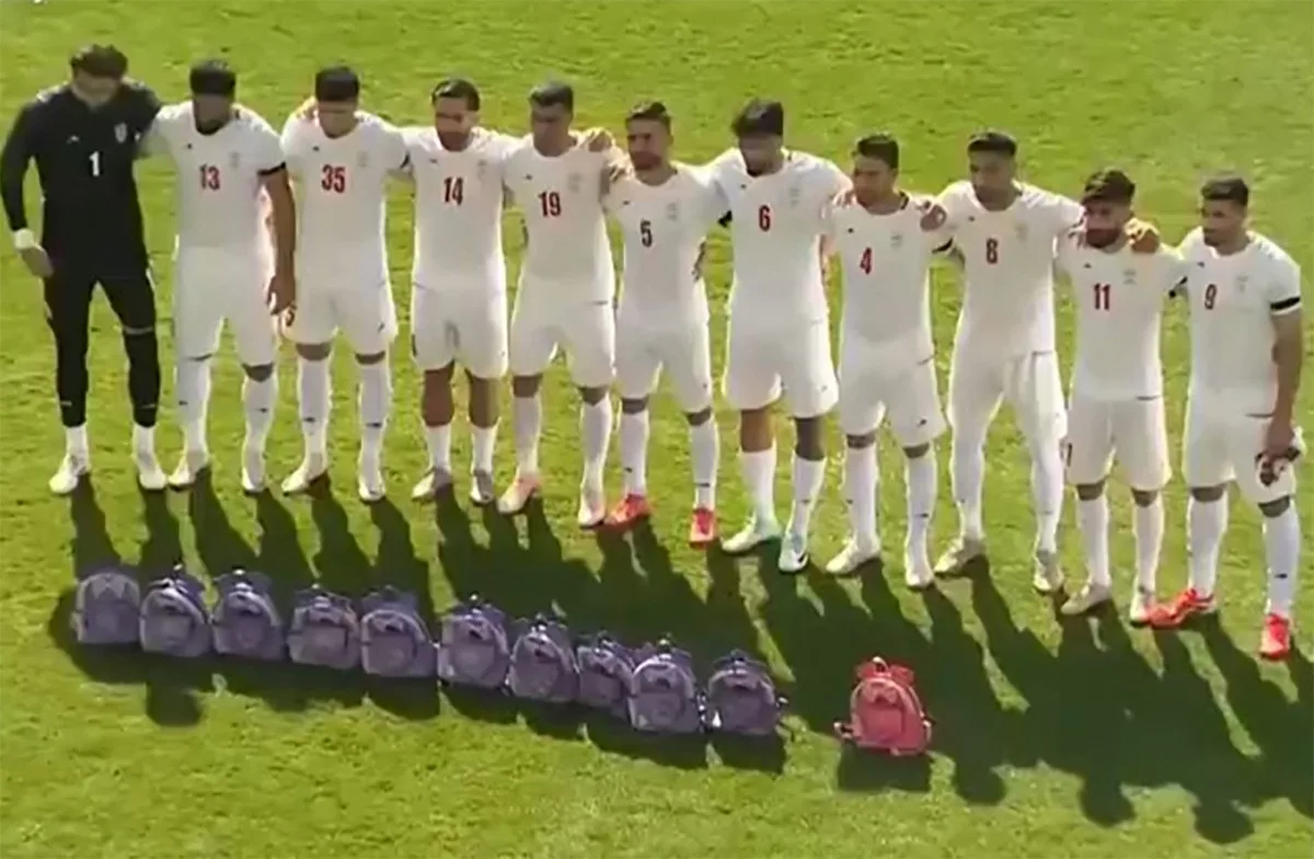 This video grab taken from images released by the Iranian state broadcaster (IRIB) on March 27, 2026 and released via AFPTV, shows the country's football national team paying tribute to the victims of the February 28 strike on an elementary school in Minab, ahead of their friendly football match with Nigeria in Turkey's Antalya. The biggest loss of life for civilians in the war so far was the airstrike on an elementary school in Minab on the first day of the war that killed at least 165 people, according to an official toll. (Photo by IRIB TV / AFP) /